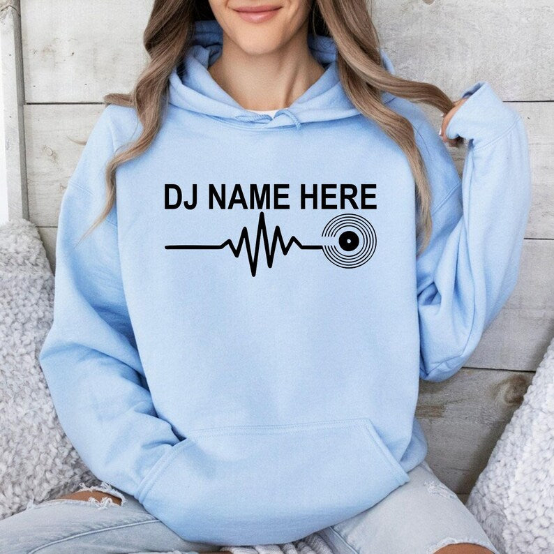 Customise this DJ Name Heartbeat Hoodie with any name to create a unique gift for DJs, music producers and vinyl lovers. Featuring a modern heartbeat graphic and premium-quality printing, every hoodie is professionally printed in the UK by TeezoraPrints.