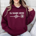 Create your own personalised DJ Name Heartbeat Hoodie by adding any custom DJ name. Featuring a heartbeat waveform flowing into a vinyl record, this premium hoodie is perfect for DJs and music lovers. Professionally printed in the UK by TeezoraPrints for lasting comfort and premium quality.