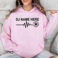 Featuring a custom DJ name, heartbeat waveform and vinyl record graphic, this personalised hoodie creates a clean modern look for DJs and music lovers. Professionally printed in the UK by TeezoraPrints using premium-quality materials.
