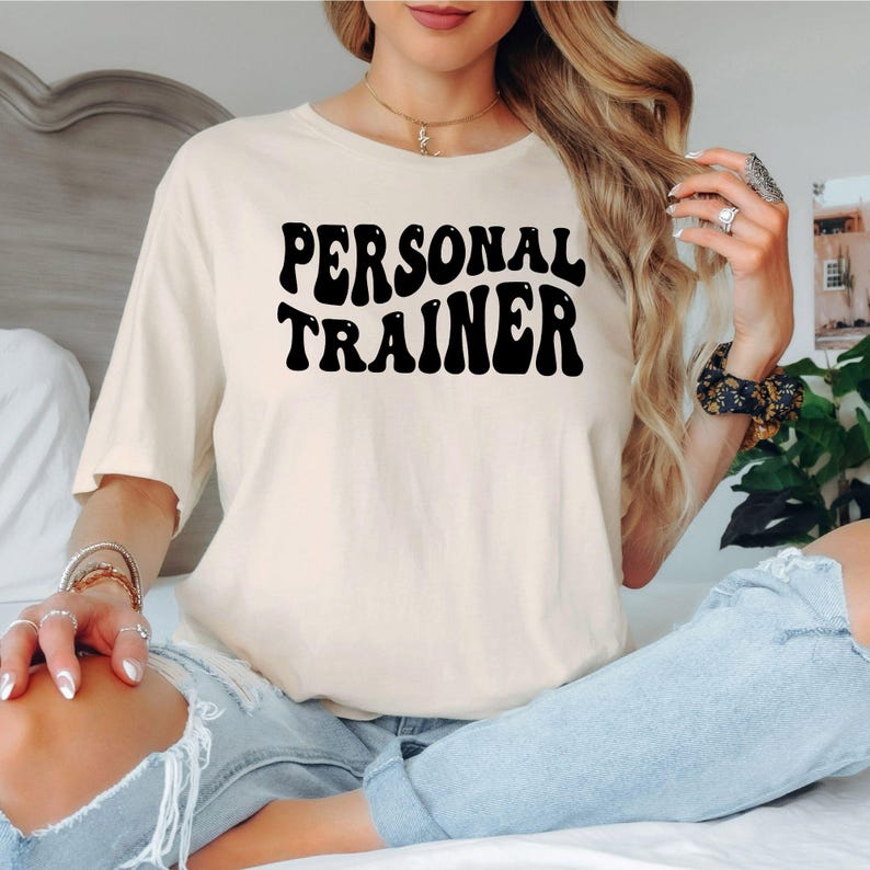 Personal Trainer T Shirt is perfect for gym sessions, personal training appointments, fitness boot camps, bodybuilding competitions, CrossFit workouts, fitness expos, health events, sports clubs, casual everyday wear, holidays, birthdays, weekend training, coaching sessions, and professional fitness environments. Teezora Prints combines premium quality with bold typography to create stylish gym apparel for dedicated trainers.