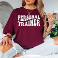 Personal Trainer T Shirt featuring bold vintage typography designed for gym instructors, fitness coaches, bodybuilding trainers, and workout professionals. Teezora Prints creates premium fitness apparel for customers searching personal trainer shirts, gym coach clothing, PT t shirts, fitness instructor apparel, workout trainer gifts, bodybuilding fashion, premium gym clothing, athletic lifestyle shirts, and unique trainer graphic tees.