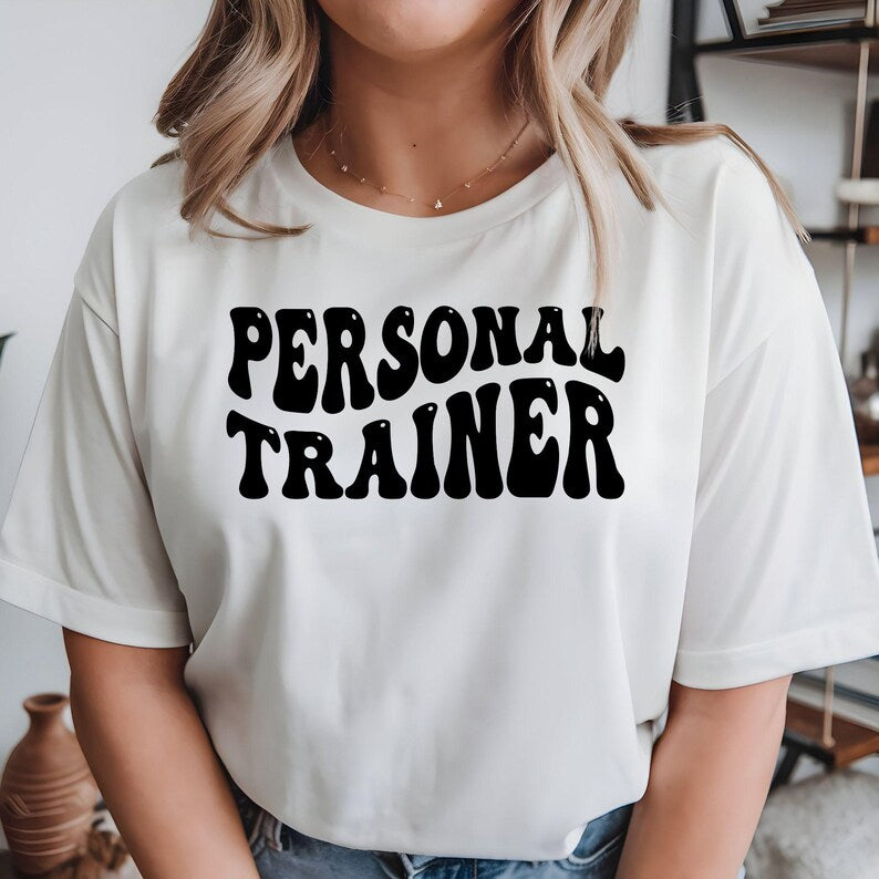 Personal Trainer Shirt, Fitness Coach T Shirt, Gym Trainer Tee, PT Shirt, Personal Training Shirt, Gym Instructor Shirt, Workout Coach Tee, Bodybuilding Shirt, Fitness Apparel, Gym Clothing, Sportswear Shirt, Strength Coach Tee, Trainer Gift, Fitness Gift, Premium Graphic T Shirt by Teezora Prints, Athletic Shirt, Exercise Coach Tee, Gym Lifestyle Shirt, Modern Fitness Clothing, Casual Gym Tee, Personal Coach Shirt, Gym Fashion, Unisex Trainer Shirt, Fitness Professional Tee.