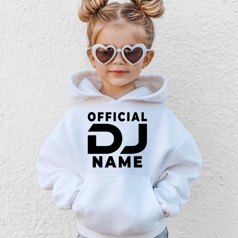 Designed for DJs, music producers, festival performers and electronic music lovers, this personalised Official DJ hoodie features your custom DJ name in a bold modern design. Perfect for live performances, studio sessions and casual everyday wear, every premium hoodie is professionally printed in the UK by TeezoraPrints using high-quality materials for warmth, comfort and durability.