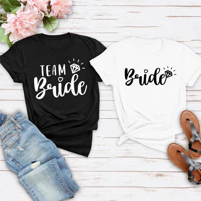 Team Bride shirt, Bride Tribe shirt, personalised bride shirt, bridesmaid t shirt, bridal shower tee, hen party shirt, bachelorette shirt, wedding morning outfit, matching bridal shirts, bridal party clothing and custom wedding apparel. Carefully produced by TeezoraPrints with premium printing and soft cotton fabric for comfortable everyday wear.