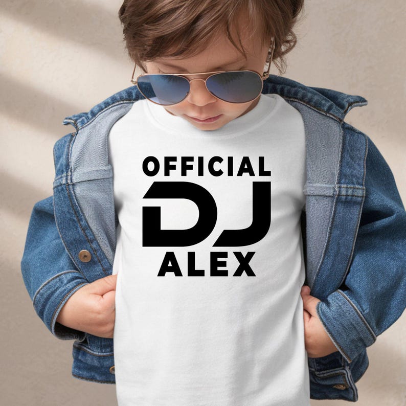 Designed for professional DJs, music producers, club performers and electronic music enthusiasts, this personalised Official DJ shirt features your custom DJ name in a bold modern design. Perfect for performances, rehearsals and everyday wear, this premium t-shirt delivers style and comfort. Every order is professionally printed in the UK by TeezoraPrints using premium-quality materials.