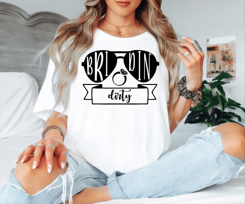Bride Squad Matching Bachelorette T Shirts created for brides, bridesmaids, maid of honour, bridal party members, and best friends celebrating unforgettable wedding moments together. Featuring the fun "They See Us Rollin' We Celebratin'" design alongside a personalised Bride shirt, this premium matching collection from Teezora Prints is perfect for hen parties, bridal showers, girls' weekends, wedding mornings, group photos, and stylish bridal celebrations with matching outfits.