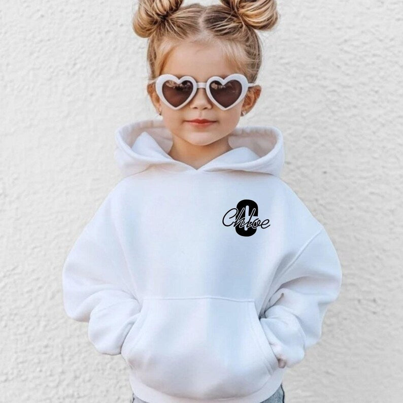 Elegant personalised hoodie featuring a modern monogram aesthetic with a bold initial and flowing script name. This fashionable custom hoodie pairs perfectly with jeans, leggings, joggers and casual footwear, creating a stylish personalised outfit suitable for year-round wear and contemporary fashion trends.