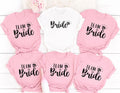 Personalised Team Bride shirt designed for brides, bridesmaids, maid of honour and every member of the bridal party. Featuring elegant script lettering with a sparkling engagement ring, this stylish bridal t-shirt is perfect for creating coordinated wedding outfits and memorable celebrations. Every shirt is professionally printed in the UK by TeezoraPrints using premium cotton for exceptional comfort and long-lasting quality.