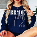 Bride To Be sweatshirt, personalised bride sweatshirt, Future Mrs jumper, engagement sweatshirt, bridal shower sweatshirt, wedding morning jumper, bride gift, fiancée sweatshirt, bridal outfit, cosy wedding sweatshirt and engagement clothing. Designed for comfort and style, every order is professionally printed in the UK by TeezoraPrints with premium quality craftsmanship.