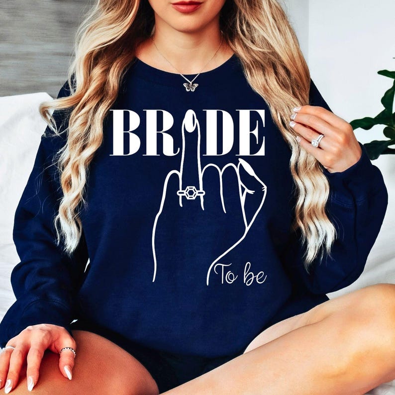 Bride To Be sweatshirt, personalised bride sweatshirt, Future Mrs jumper, engagement sweatshirt, bridal shower sweatshirt, wedding morning jumper, bride gift, fiancée sweatshirt, bridal outfit, cosy wedding sweatshirt and engagement clothing. Designed for comfort and style, every order is professionally printed in the UK by TeezoraPrints with premium quality craftsmanship.