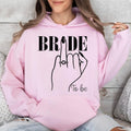 Personalised Bride To Be hoodie created for brides, fiancées and future wives celebrating one of life's most memorable milestones. Featuring an elegant bride illustration with a sparkling engagement ring and stylish 