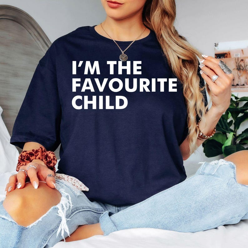 Looking for the perfect gift for a sibling with a great sense of humour? This I'm The Favourite Child T Shirt from Teezora Prints features a bold typography design that instantly becomes the centre of attention. Professionally printed on a premium quality unisex t shirt, it offers exceptional comfort, long-lasting durability, and timeless style. Perfect for birthdays, Christmas, family reunions, Mother's Day, Father's Day, sibling gifts, and anyone who loves playful family jokes.