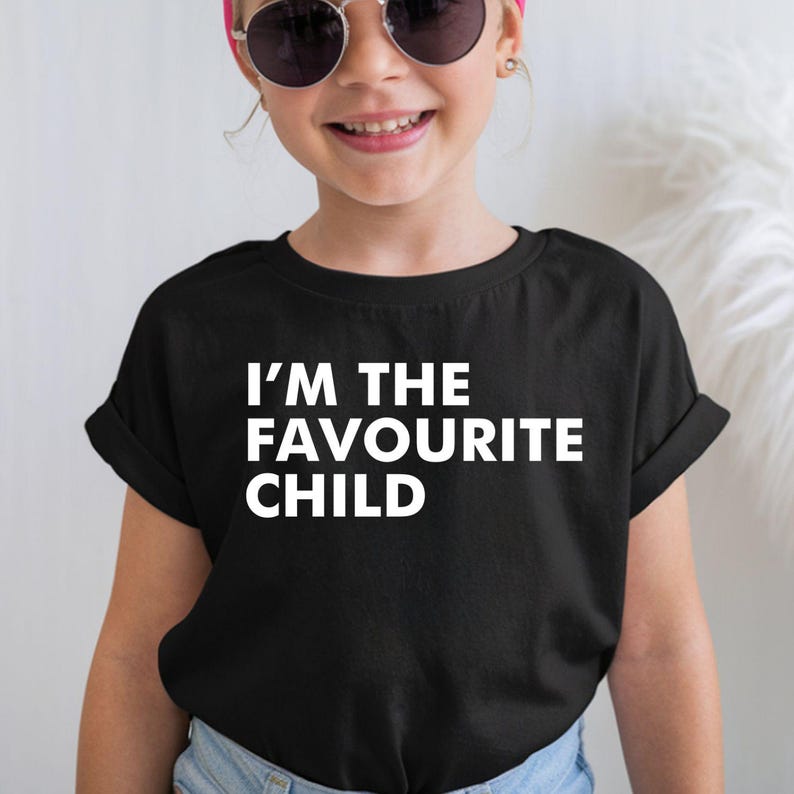 I'm The Favourite Child T Shirt created for siblings, brothers, sisters, mums, dads, family humour lovers, sarcastic personalities, and anyone who enjoys playful family banter. Featuring bold typography with a clean minimalist design, this premium graphic tee from Teezora Prints delivers exceptional comfort, premium print quality, and stylish everyday fashion while making a hilarious statement that's guaranteed to get laughs at family gatherings and special occasions.