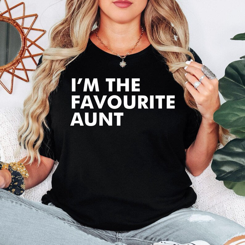 I'm The Favourite Aunt T Shirt created for proud aunts, cool aunties, family members, sisters, godmothers, best friends, and women who love celebrating the special bond with their nieces and nephews. Featuring bold minimalist typography, this premium graphic tee from Teezora Prints combines comfort, premium print quality, and stylish everyday fashion while making a fun family statement that's perfect for every favourite aunt.