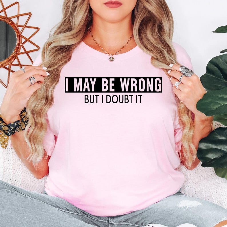 Funny sarcastic t shirt designed for men and women who enjoy witty humour, clever one-liners, and confident personalities. Featuring the quote "I May Be Wrong But I Doubt It" in a bold minimalist typography design, this premium graphic tee is perfect for friends, family members, work colleagues, husbands, wives, and anyone who loves making people laugh. A comfortable everyday shirt that combines humour, confidence, individuality, and modern casual fashion for every occasion.