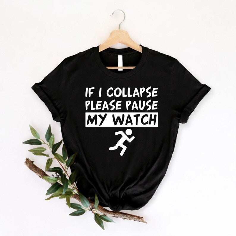 Funny marathon running t shirt featuring the quote "If I Collapse Please Pause My Watch" with a runner graphic. Ideal for customers searching marathon runner shirts, funny jogging t shirts, running quote tees, parkrun clothing, gym humour apparel, fitness slogan shirts, runner gifts, race day outfits, workout clothing, endurance running apparel, and unique sports fashion.