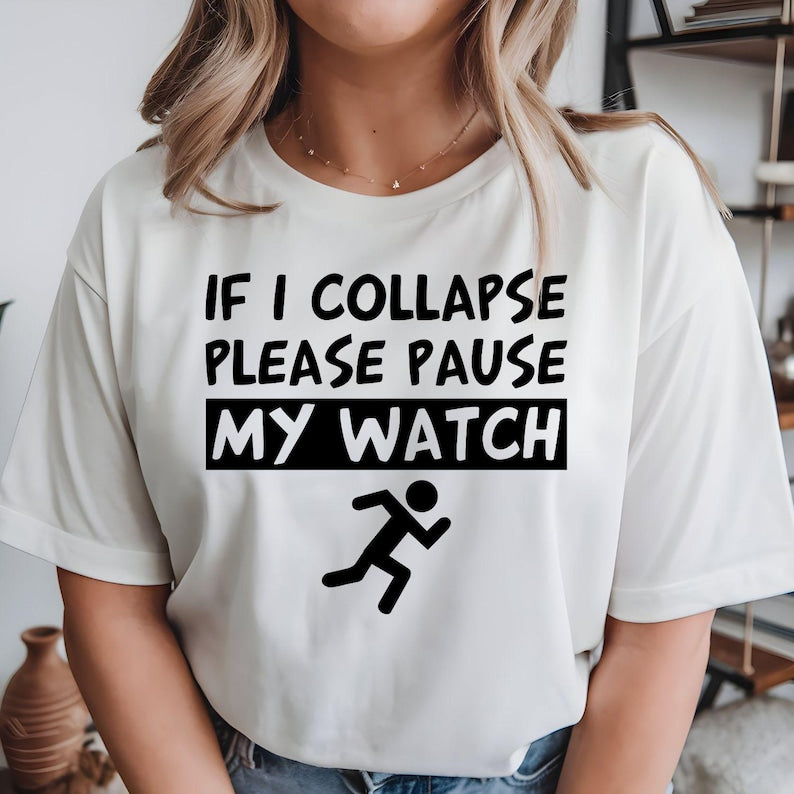 Funny running t shirt designed for marathon runners, joggers, gym lovers, fitness enthusiasts, parkrun participants, and active people who enjoy motivational humour. Featuring the quote "If I Collapse Please Pause My Watch" with a running icon, this premium graphic tee is perfect for athletes, trainers, runners, and sports lovers looking for comfortable everyday fitness clothing with a funny statement.