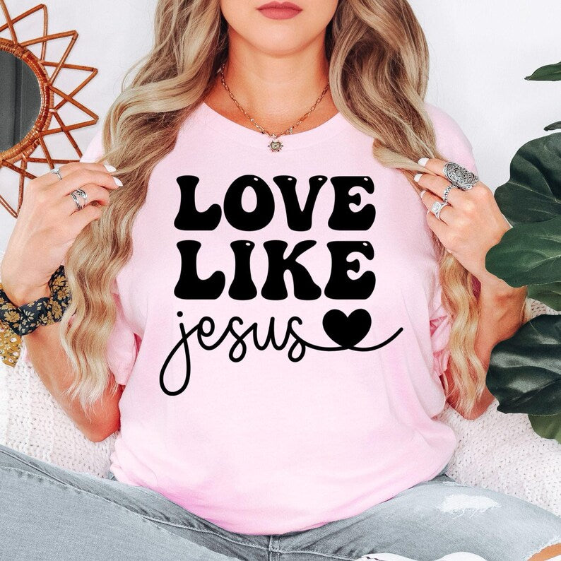 Love Like Jesus Christian t shirt designed for men and women who proudly live their Christian faith and enjoy inspirational Bible-based clothing. Featuring a bold "Love Like Jesus" message with a stylish typography design, this premium graphic tee is perfect for believers, church members, worship leaders, Bible study groups, youth ministries, pastors, family members, and anyone who wants to share God's love through meaningful Christian apparel.
