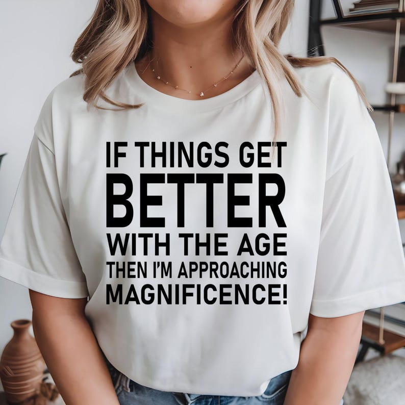 Funny birthday t shirt designed for men and women who enjoy witty humour, sarcastic quotes, and celebrating birthdays with confidence. Featuring the quote "If Things Get Better With Age Then I'm Approaching Magnificence" in a bold typography design, this premium graphic tee is perfect for friends, parents, husbands, wives, colleagues, and anyone who loves making people laugh while embracing another year with style and personality.