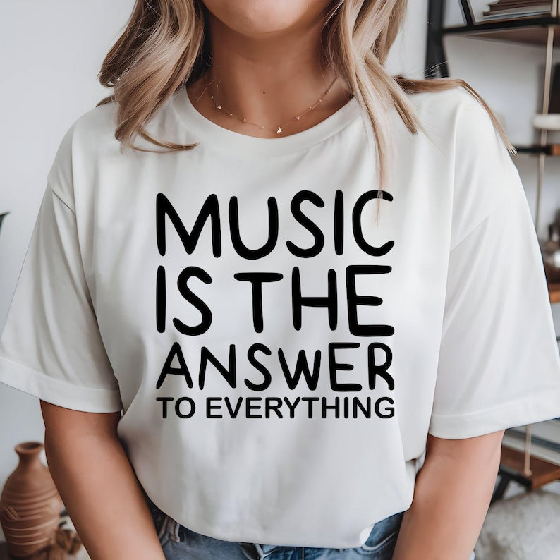 Music Is The Answer To Everything t shirt designed for musicians, singers, DJs, music teachers, students, choir members, band performers, and passionate music lovers. Featuring a bold typography design with an inspirational message, this premium graphic tee is perfect for anyone who believes music brings happiness, inspiration, and positivity while enjoying concerts, rehearsals, festivals, or everyday casual wear.