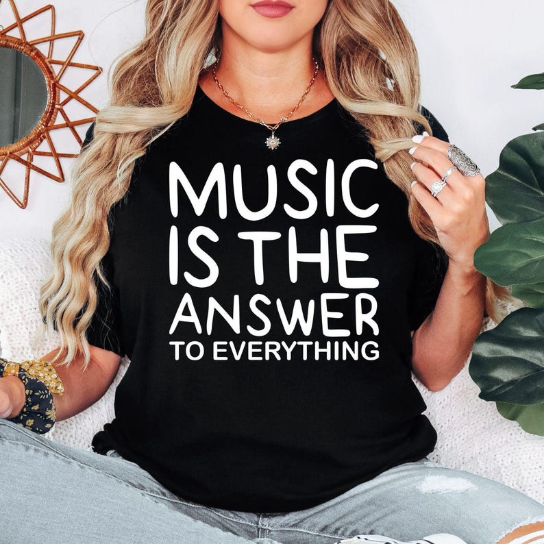 Music Is The Answer To Everything t shirt designed for musicians, singers, DJs, music teachers, students, choir members, band performers, and passionate music lovers. Featuring a bold typography design with an inspirational message, this premium graphic tee is perfect for anyone who believes music brings happiness, inspiration, and positivity while enjoying concerts, rehearsals, festivals, or everyday casual wear.