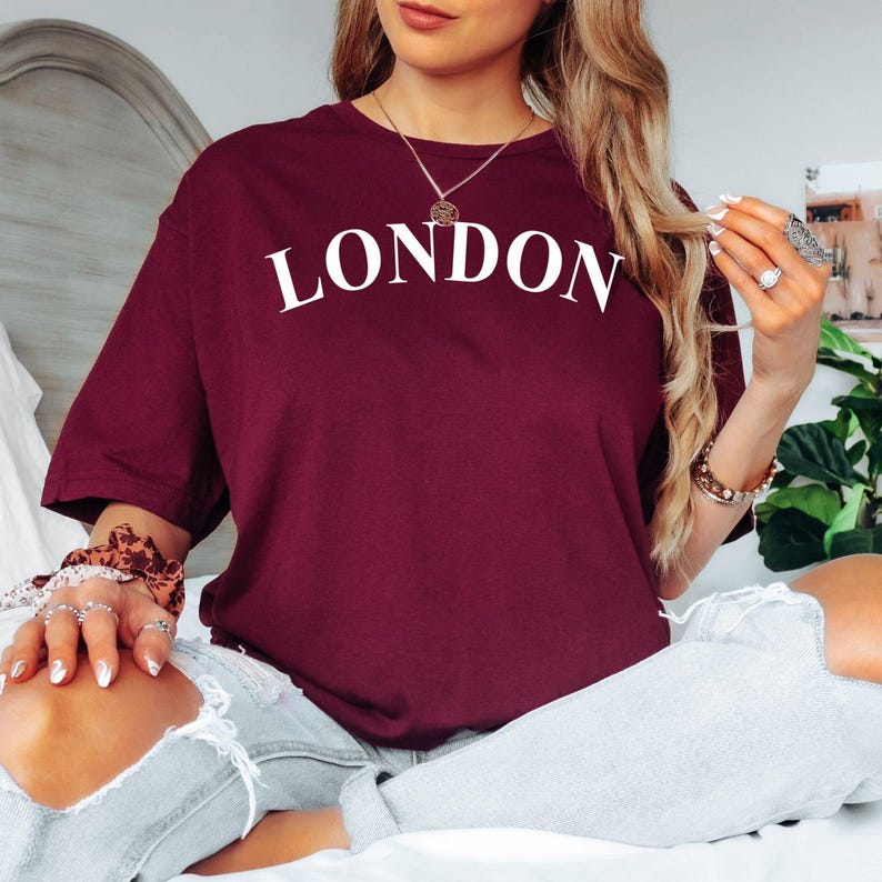 Custom City Name T Shirt with minimalist typography design personalised with your chosen city, town, country, or destination. Perfect for customers searching personalised city shirts, travel lover gifts, destination apparel, custom location clothing, personalised travel keepsakes, holiday fashion, city pride clothing, and unique personalised typography t shirts. A stylish option for meaningful personalised gifting and travel-inspired fashion.