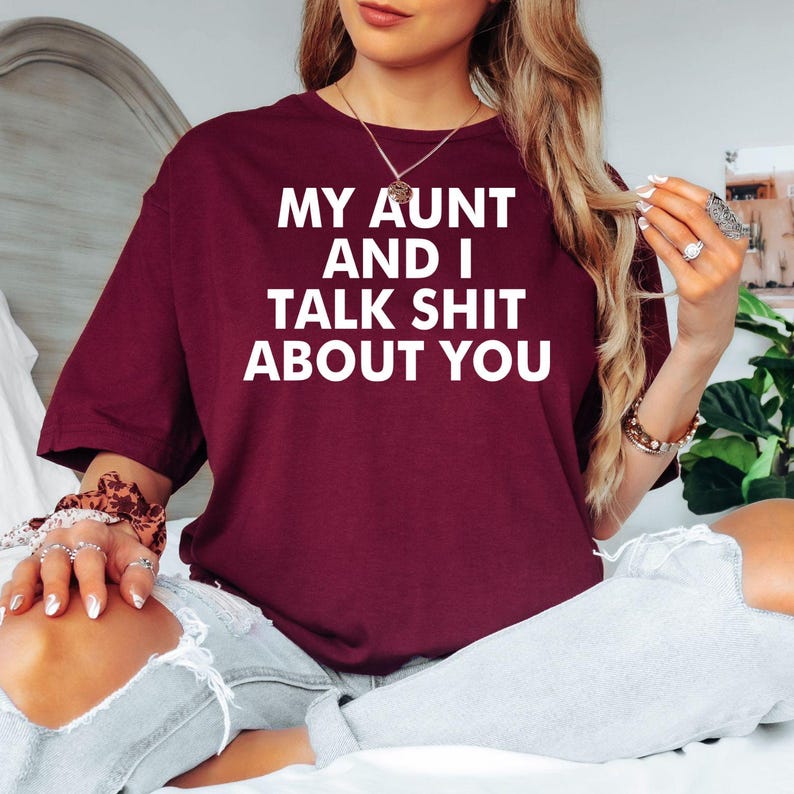 My Aunt And I Talk Shit About You t shirt created for aunts, nieces, nephews, sisters, cousins, best friends, and anyone who loves sarcastic family humour with a bold personality. Featuring an eye-catching typography design, this premium graphic tee celebrates close family relationships, inside jokes, confidence, and unforgettable laughter. Perfect for casual everyday wear, family gatherings, girls' weekends, holidays, birthdays, reunions, and anyone who enjoys playful humour with the people they love most.