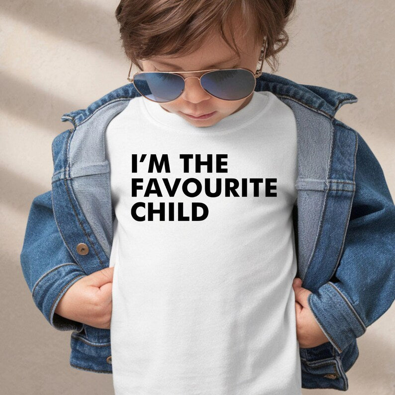 I'm The Favourite Child T Shirt created for siblings, brothers, sisters, mums, dads, family humour lovers, sarcastic personalities, and anyone who enjoys playful family banter. Featuring bold typography with a clean minimalist design, this premium graphic tee from Teezora Prints delivers exceptional comfort, premium print quality, and stylish everyday fashion while making a hilarious statement that's guaranteed to get laughs at family gatherings and special occasions.
