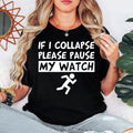 If I Collapse Please Pause My Watch T Shirt featuring a funny running quote, marathon humour design, fitness graphic apparel, runner slogan shirt, jogging t shirt, gym humour clothing, workout shirt, sports apparel, and premium printed fashion. Perfect for customers searching funny running shirts, marathon t shirts, runner gifts, jogging apparel, fitness clothing, athlete gifts, and novelty sports t shirts.