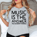 Searching for the perfect gift for a music lover? This Music Is The Answer To Everything t shirt features a bold typography design with a timeless inspirational message. Professionally printed on a premium quality t shirt, it provides comfort, durability, and everyday style. Perfect for birthdays, Christmas, concerts, music festivals, rehearsals, choir practice, and thoughtful gifts for musicians, singers, teachers, and DJs.