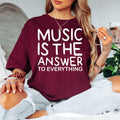 Music Is The Answer To Everything t shirt featuring a bold music quote and modern typography design. Perfect for customers searching music lover shirts, musician t shirts, music teacher gifts, band clothing, choir shirts, concert apparel, inspirational music tees, singer gifts, DJ clothing, and premium music graphic fashion for everyday wear.