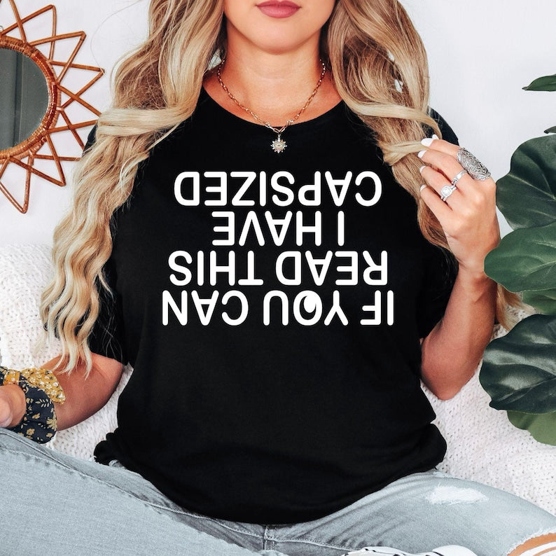 If You Can Read This I Have Capsized t shirt designed for passionate kayakers, canoe enthusiasts, paddle boarders, whitewater adventurers, outdoor explorers, campers, boaters, and water sports lovers who enjoy adding humour to every adventure. Featuring a bold upside-down typography design with a hilarious kayaking joke, this premium graphic tee is perfect for lake weekends, river expeditions, kayaking clubs, camping holidays, family adventures, and anyone who believes every capsize becomes the best story t