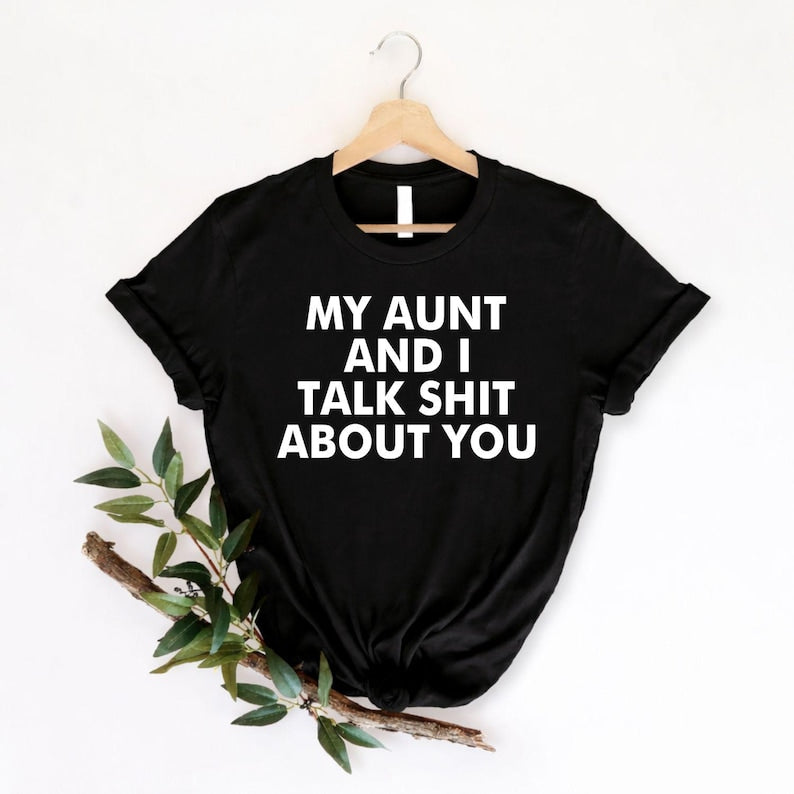Searching for a hilarious gift for your favourite aunt? This My Aunt And I Talk Shit About You t shirt features a bold typography design with a cheeky family joke that instantly grabs attention. Professionally printed on a premium quality unisex t shirt, it offers outstanding comfort, durability, and everyday style. Perfect for birthdays, Christmas, family reunions, girls' trips, holidays, and anyone who enjoys sarcastic humour and unforgettable family banter.