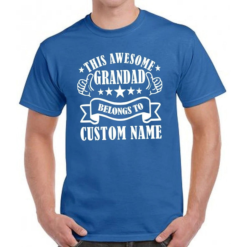 Personalised family grandad graphic tee with custom names and thumbs up typography artwork designed for proud grandfathers. Funny and sentimental unisex t shirt suitable for Fathers Day gifting, Christmas presents, grandpa birthdays and family celebrations. Meaningful keepsake clothing for grandads who enjoy personalised family fashion and custom name graphic apparel throughout the year.