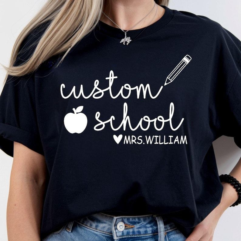 Personalised Teacher T Shirt created for teachers, teaching assistants, nursery teachers, primary school teachers, secondary school teachers, tutors, preschool educators, classroom assistants, homeschool teachers, and education professionals. Featuring a custom school name, teacher name, pencil illustration, and apple icon, this premium personalised teacher gift from Teezora Prints delivers exceptional comfort, premium print quality, and stylish classroom fashion for everyday teaching.