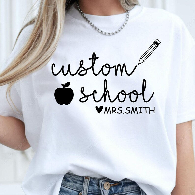 Personalised Teacher T Shirt created for teachers, teaching assistants, nursery teachers, primary school teachers, secondary school teachers, tutors, preschool educators, classroom assistants, homeschool teachers, and education professionals. Featuring a custom school name, teacher name, pencil illustration, and apple icon, this premium personalised teacher gift from Teezora Prints delivers exceptional comfort, premium print quality, and stylish classroom fashion for everyday teaching.