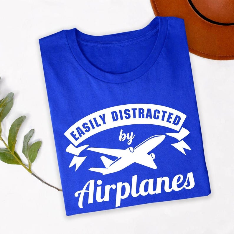 Easily Distracted By Airplanes t shirt makes a memorable gift for pilots, aviation students, cabin crew, aerospace engineers, aircraft mechanics, travellers, plane spotters, flight instructors, airport workers, aviation photographers, family members, friends, and anyone fascinated by flying. This premium graphic shirt is perfect for birthdays, Christmas, Father's Day, Mother's Day, pilot graduation, aviation club events, retirement celebrations, and thoughtful gifts for airplane lovers.