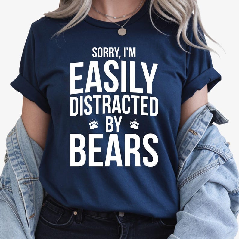 Teezora Prints Searching for the perfect gift for someone who loves bears and the outdoors? This Sorry I'm Easily Distracted By Bears T Shirt features a bold typography design with playful paw print details that every wildlife enthusiast will appreciate. Professionally printed on a premium quality unisex t shirt, it offers outstanding comfort, long-lasting durability, and timeless style. Perfect for birthdays, Christmas, camping trips, hiking adventures, wildlife holidays, Father's Day, Mother's Day, and th