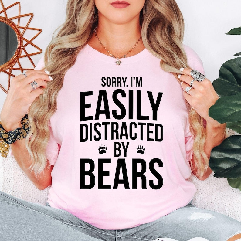 Teezora Prints Sorry I'm Easily Distracted By Bears T Shirt makes a memorable gift for bear lovers, campers, hikers, wildlife photographers, outdoor explorers, park rangers, hunters, animal enthusiasts, dads, mums, husbands, wives, brothers, sisters, friends, and anyone who enjoys nature. This premium graphic shirt is perfect for birthdays, Christmas, Father's Day, Mother's Day, retirement gifts, camping holidays, hiking weekends, and special occasions for wildlife lovers.