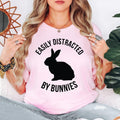 Easily Distracted By Bunnies T Shirt makes a thoughtful gift for bunny mums, bunny dads, rabbit owners, pet lovers, animal rescuers, veterinary nurses, breeders, family members, friends, daughters, sons, husbands, wives, and anyone who adores rabbits. Created by Teezora Prints, this premium graphic shirt is ideal for birthdays, Easter, Christmas, Mother's Day, Father's Day, adoption anniversaries, appreciation gifts, and memorable surprises for bunny enthusiasts.