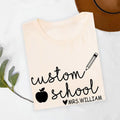 Personalised Teacher T Shirt is designed for educators who inspire students every day while expressing their passion for teaching. Whether you're preparing lessons, teaching in the classroom, attending school events, meeting parents, or celebrating Teacher Appreciation Week, this premium personalised tee from Teezora Prints reflects your dedication. Featuring a custom school name, teacher name, pencil illustration, and apple icon, it's ideal for comfortable everyday school wear.