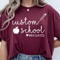 Looking for the perfect personalised teacher gift? This Personalised Teacher T Shirt from Teezora Prints features your custom school name and teacher name with a stylish apple and pencil design, creating a unique classroom outfit. Professionally printed on a premium quality unisex t shirt, it delivers outstanding comfort, durability, and style. Perfect for Teacher Appreciation Week, back to school, end of term gifts, birthdays, Christmas, graduations, and everyday classroom wear.