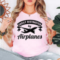 Easily Distracted By Airplanes t shirt is perfect for airshows, airport visits, aviation museums, flying lessons, pilot training, travel holidays, aircraft exhibitions, aviation club meetings, family vacations, birthdays, casual everyday wear, photography trips, aviation festivals, weekend adventures, flight simulator events, and social gatherings. The bold airplane silhouette and modern typography create a striking conversation starter while celebrating a lifelong passion for aviation and flight.
