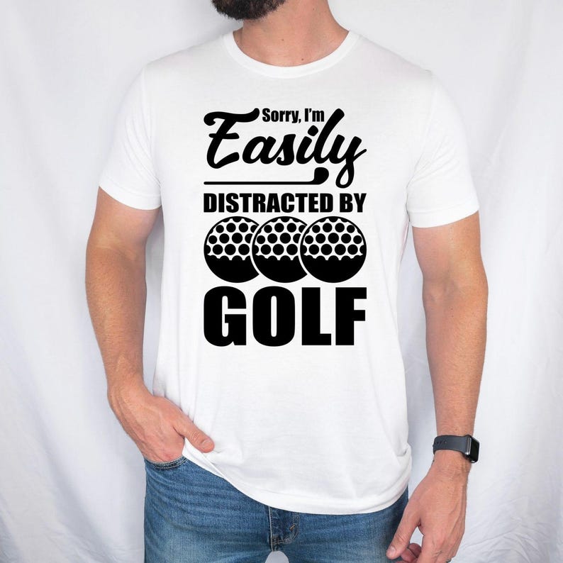 Teezora Prints Sorry I'm Easily Distracted By Golf T Shirt created for golfers, golf enthusiasts, weekend players, golf club members, PGA fans, golf coaches, retirees, dads, mums, and anyone whose favourite place is the golf course. Featuring bold typography with realistic golf balls, this premium graphic tee reflects the passion every golfer feels while delivering exceptional comfort, durable print quality, stylish everyday fashion, and a fun personality that instantly connects with fellow golf lovers on a