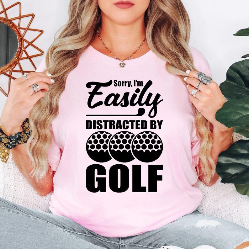 Teezora Prints Sorry I'm Easily Distracted By Golf T Shirt makes an unforgettable gift for golfers, golf coaches, golf club members, dads, mums, grandads, husbands, wives, brothers, sisters, friends, colleagues, and anyone passionate about golf. This premium graphic shirt is perfect for birthdays, Father's Day, Mother's Day, Christmas, retirement celebrations, golf tournaments, club championships, Secret Santa, and thoughtful gifts for every golf enthusiast.