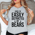 Teezora Prints Sorry I'm Easily Distracted By Bears T Shirt designed for people who feel happiest exploring forests, mountains, hiking trails, and national parks where wildlife thrives. Featuring a bold typography design with paw print graphics, this premium graphic tee is perfect for campers, adventurers, outdoor lovers, and anyone proud to show their love for bears. Ideal for travel, camping holidays, hiking adventures, weekend escapes, wildlife photography,stylish everyday casual wear inspired nature.