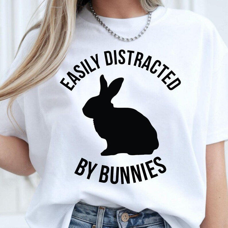Funny Bunny Shirt, Easily Distracted By Bunnies Shirt, Rabbit Lover T Shirt, Bunny Graphic Tee, Pet Rabbit Shirt, Bunny Mum Shirt, Bunny Dad Shirt, Rabbit Owner Shirt, Animal Lover Tee, Bunny Gift, Rabbit Gift, Cute Bunny Shirt, Bunny Apparel, Rabbit Graphic Tee, Funny Animal Shirt, Pet Lover Clothing, Premium Graphic T Shirt by Teezora Prints, Casual Bunny Fashion, Rabbit Lover Gift, Bunny Lover Apparel.