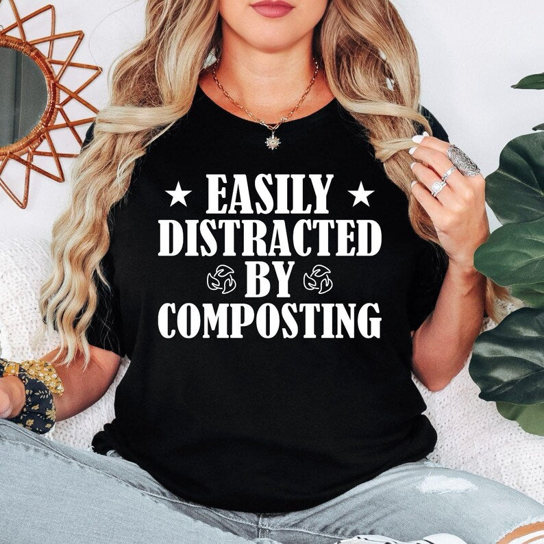 Perfect for gardeners, compost enthusiasts, plant lovers and anyone passionate about sustainable living, this Easily Distracted by Composting shirt adds humour to every gardening day. Whether you're working in the garden, managing an allotment or creating nutrient-rich compost, this premium graphic tee combines comfort with personality. Every shirt is professionally printed in the UK by TeezoraPrints for exceptional quality and long-lasting wear.