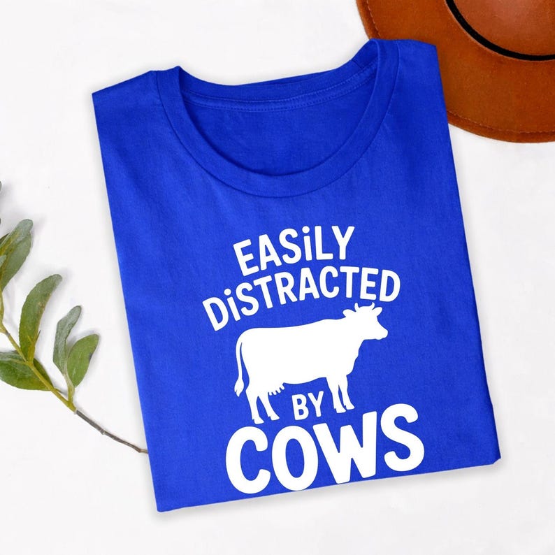 Perfect for farm visits, agricultural shows, livestock exhibitions, countryside holidays, ranch work, outdoor adventures, farmers' markets, county fairs and casual everyday wear. This funny cow lover shirt blends comfort with personality, while every order is professionally printed in the UK by TeezoraPrints using premium-quality printing for long-lasting wear.