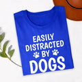 Perfect for dog walks, pet adoption days, dog training classes, animal rescue events, pet expos, countryside holidays, family outings and casual everyday wear. This Easily Distracted by Dogs shirt combines comfort, humour and style, while every premium t-shirt is professionally printed in the UK by TeezoraPrints using high-quality materials.